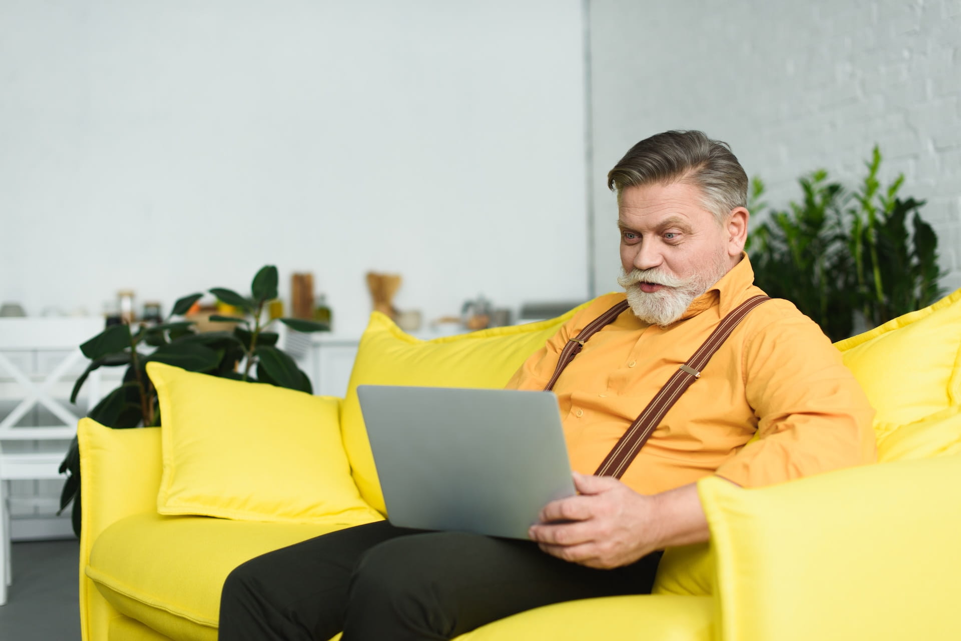 smiling-bearded-senior-man-using-laptop-while-sitt-2026-01-06-00-04-57-utc (1)